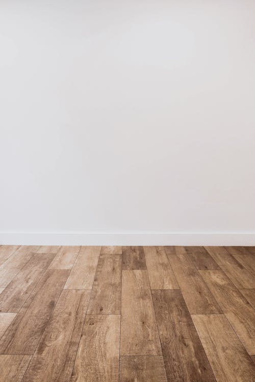 Free Wooden Flooring against White Wall  Stock Photo