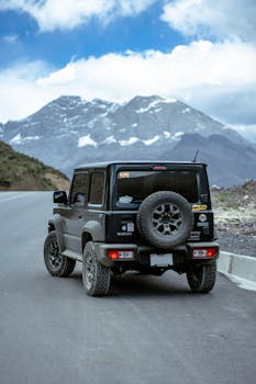 4x4 vehicle on a scenic mountain road in Canta, Peru, showcasing rugged outdoor adventure.