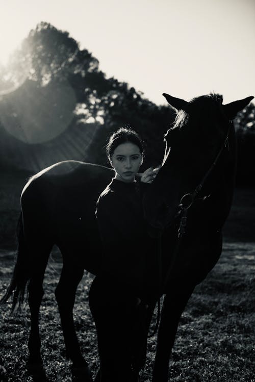 Grayscale Photo of a Woman and a Horse 