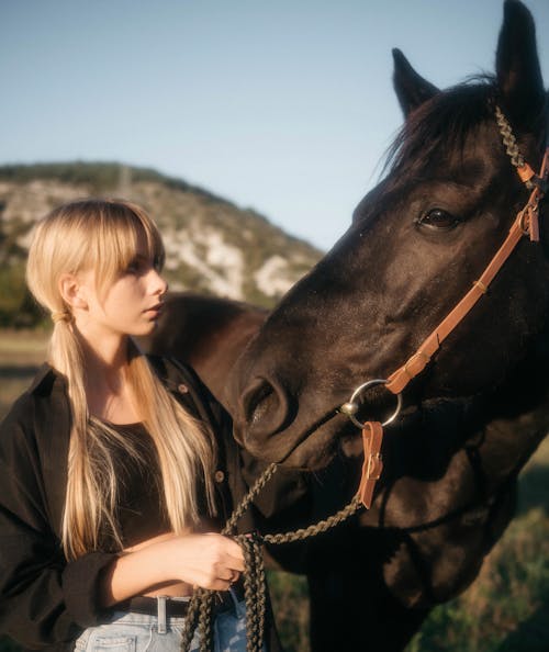 Girl Standing next to Horse