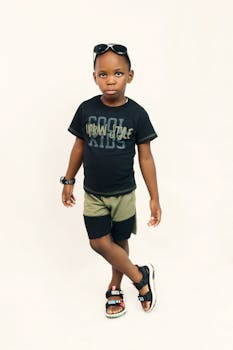 Charming young boy in trendy urban style posing confidently in a studio setting.