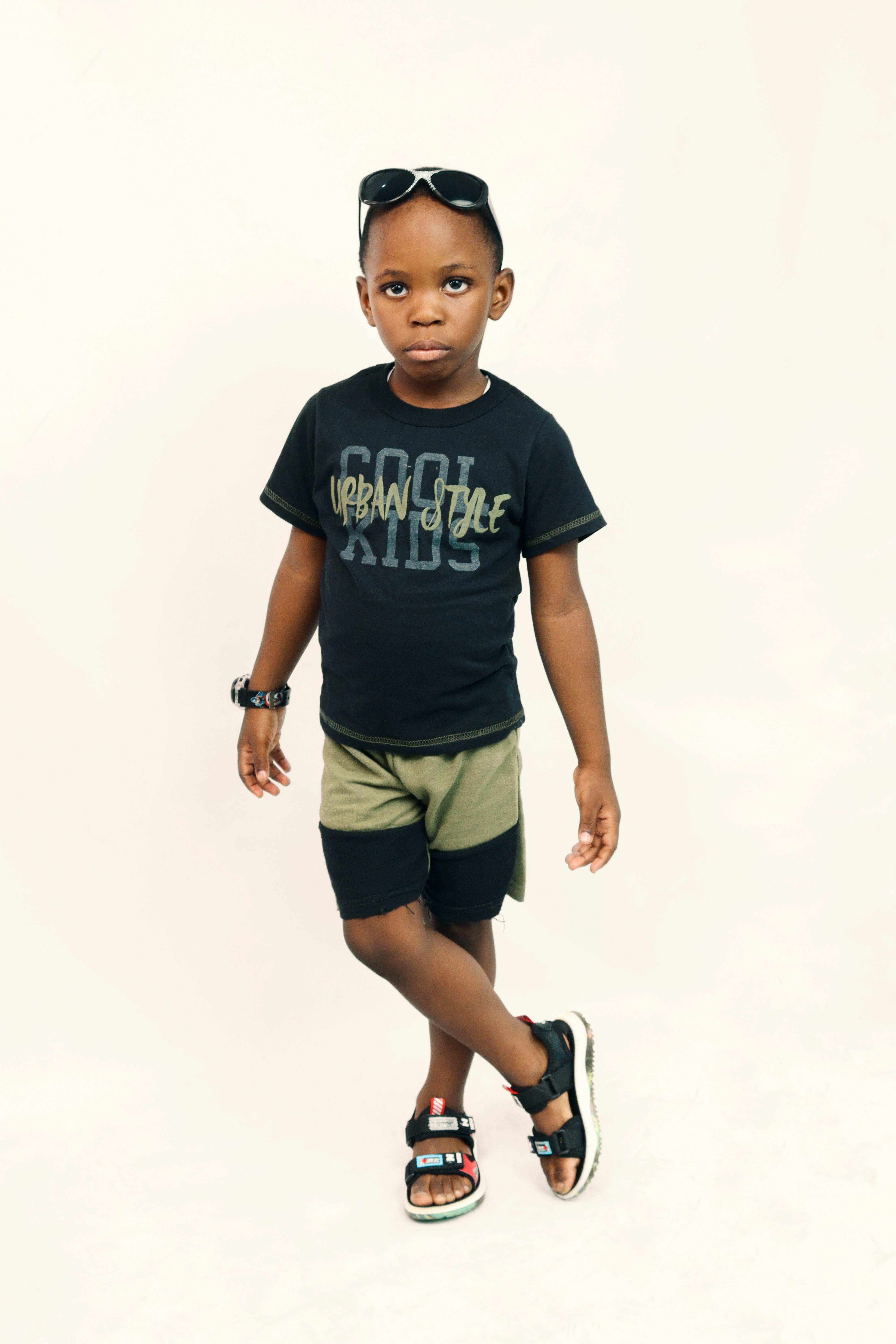 A boy portrait, young little cute and adorable kid, little obstreperous  scamp. Poses, face expressions, ease, having fun, black background Stock  Photo - Alamy