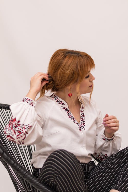 Woman Sitting on Chair and Posing