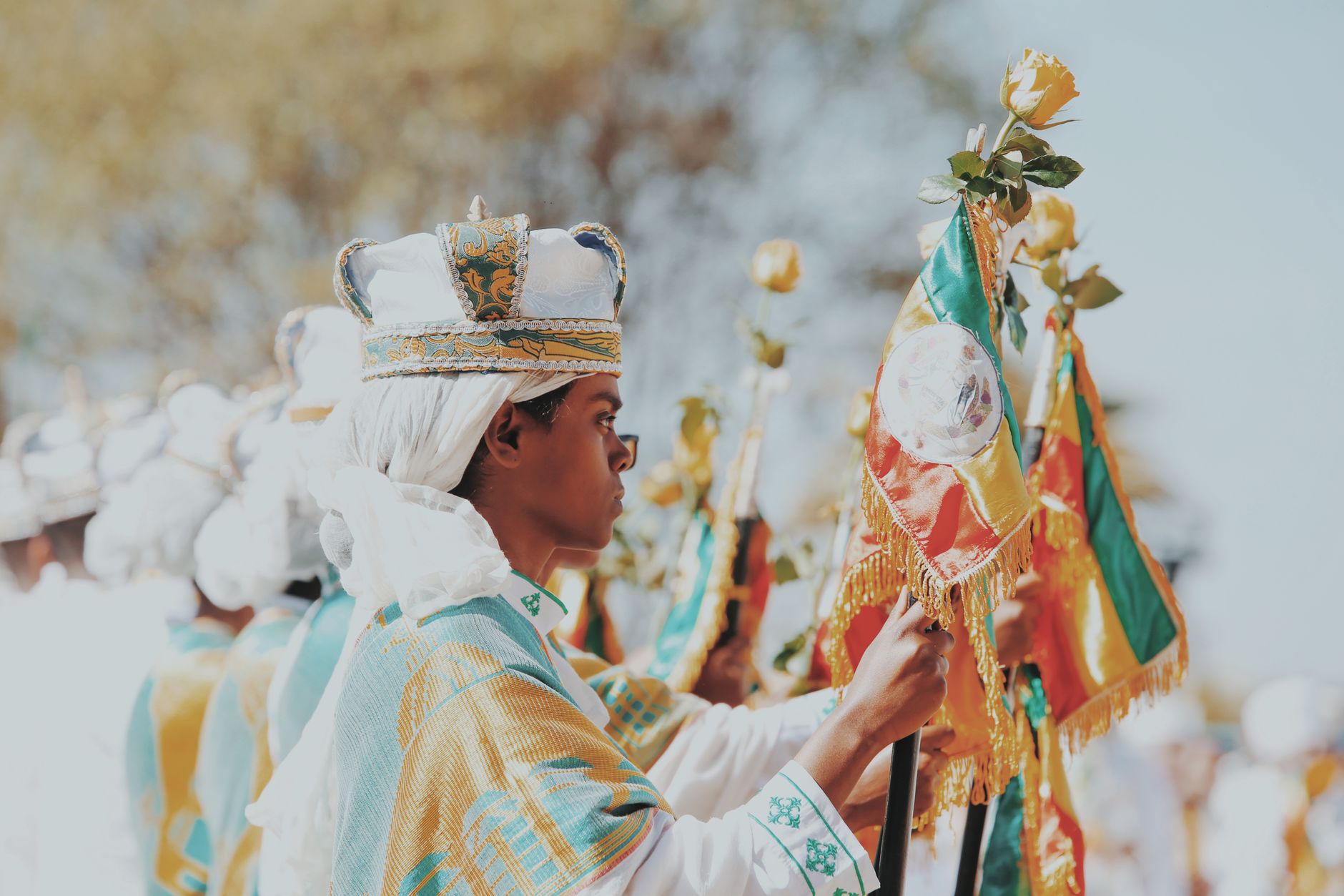 Traditional Ethiopian ceremony featuring ornate flags and vibrant cultural attire.