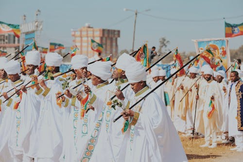 Men Holding Flags on Traditional Ceremony