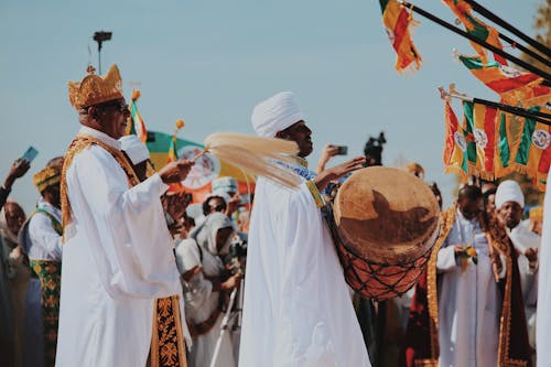 Men in Traditional Clothing with Drum and Crown on Ceremony