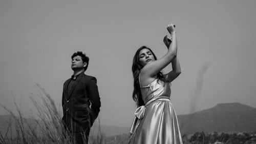 Free Stylish couple posing outdoors in grayscale, highlighting elegance and fashion. Stock Photo