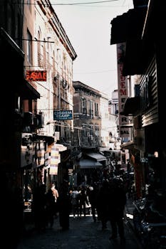 Picturesque street view in an old town with people walking amidst historic architecture.