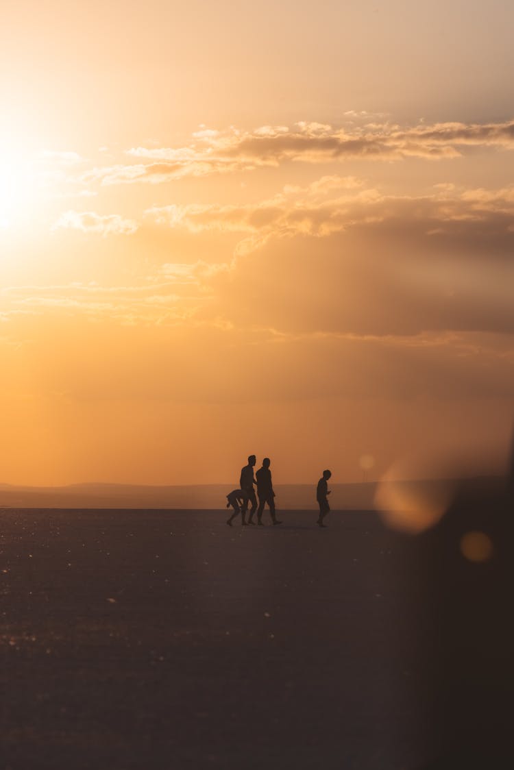 People Walking On Desert Under Sunlight