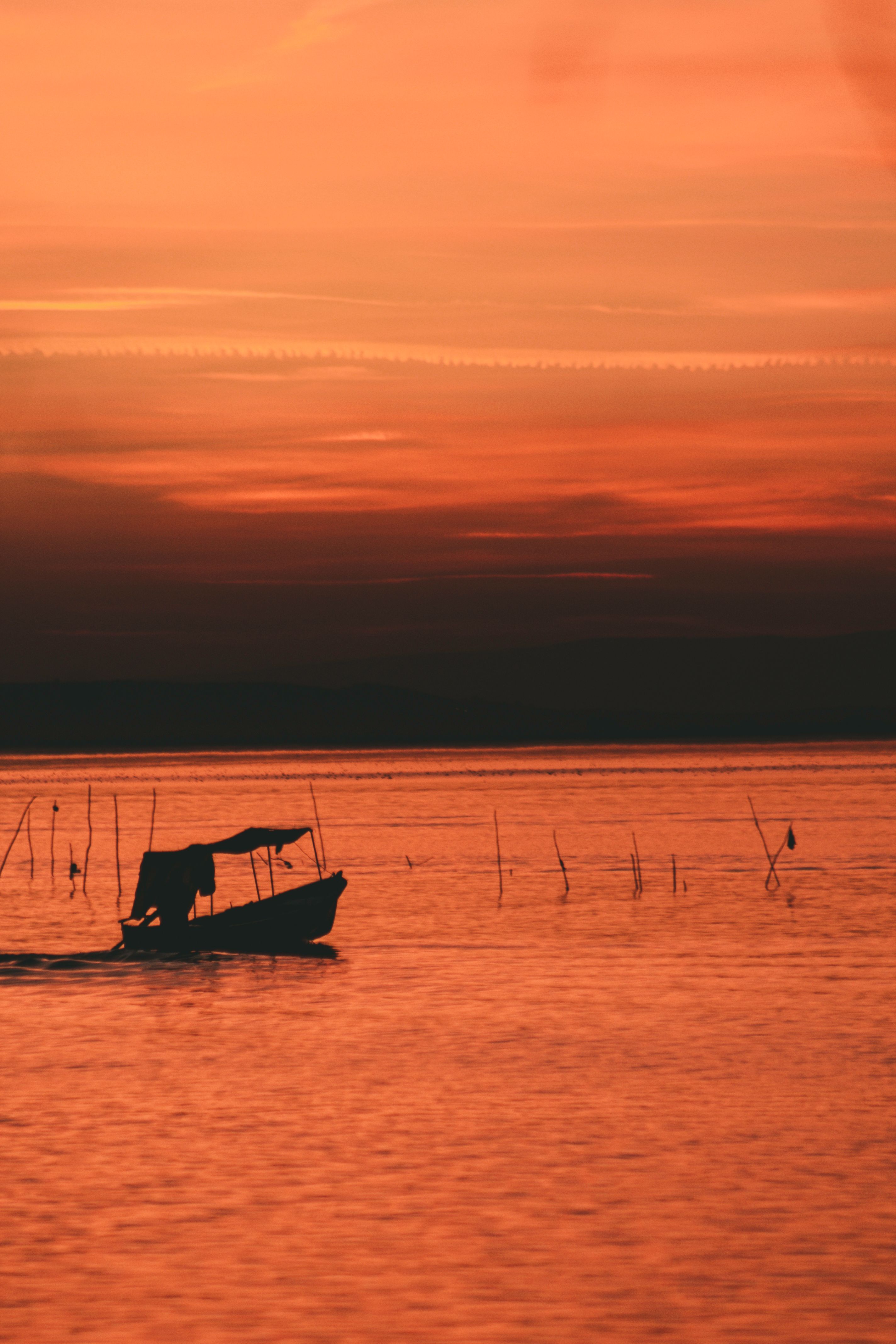 Silhouette of Boat on Body of Water · Free Stock Photo
