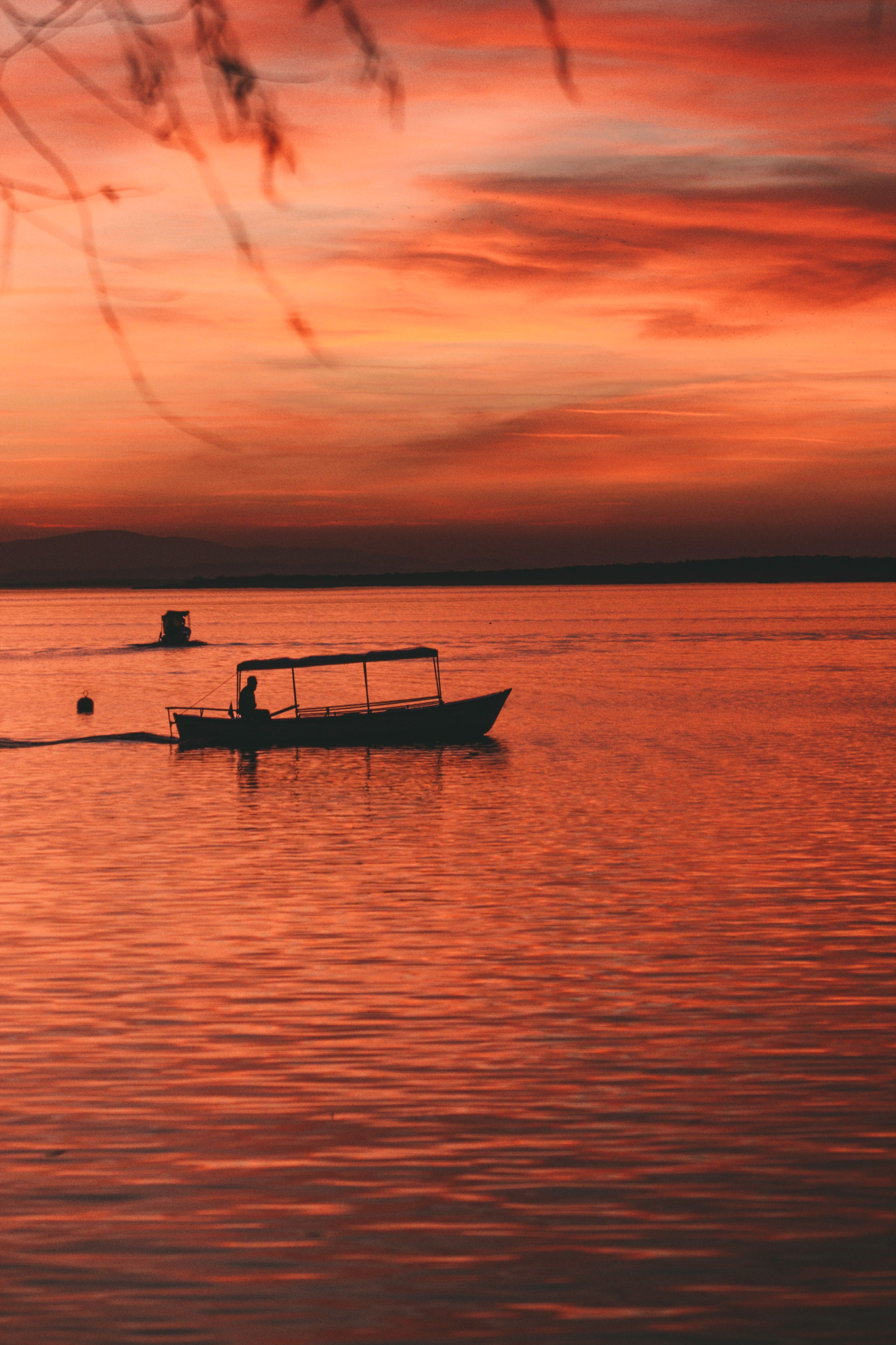 Silhouette of Person Riding a Boat on Body of Water · Free Stock Photo