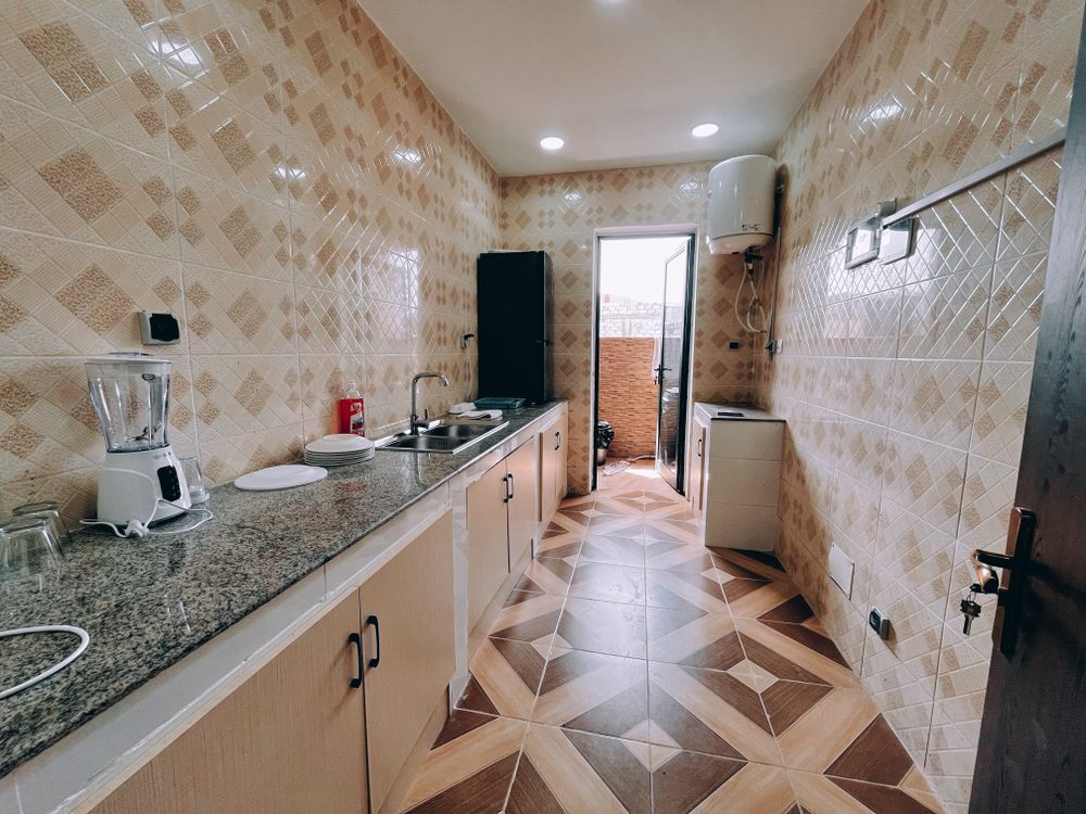 Kitchen with modern appliances and patterned tile