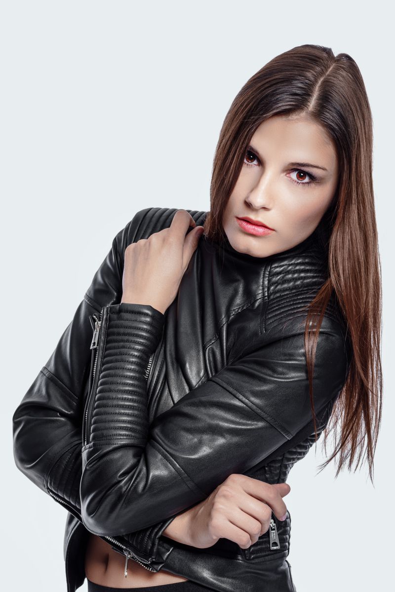 Woman in leather jacket with a belted shirt dress