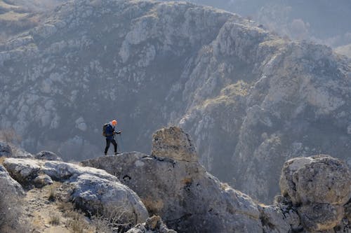 Man Hiking Across Mountains