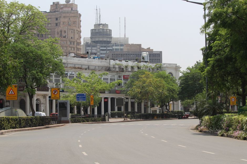A serene view of Connaught Place with empty streets and iconic buildings in the background.