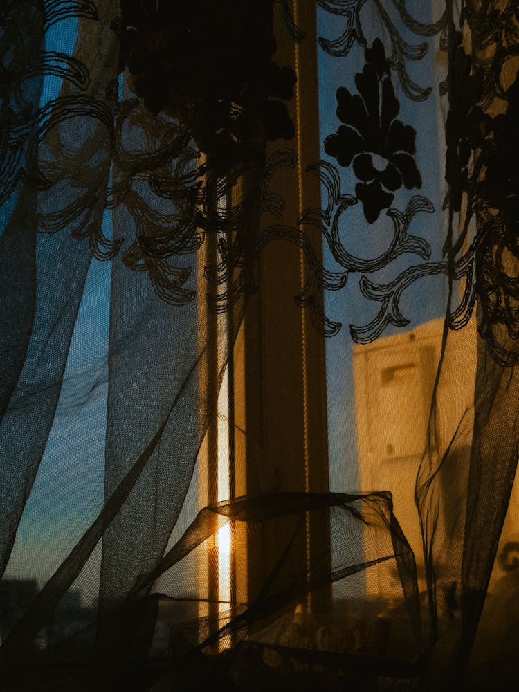 A Window With A Sheer Curtain