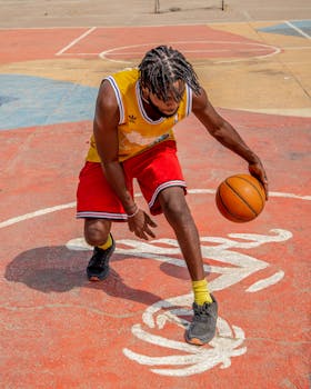 Dynamic action shot of an African man dribbling on a colorful Lagos basketball court.