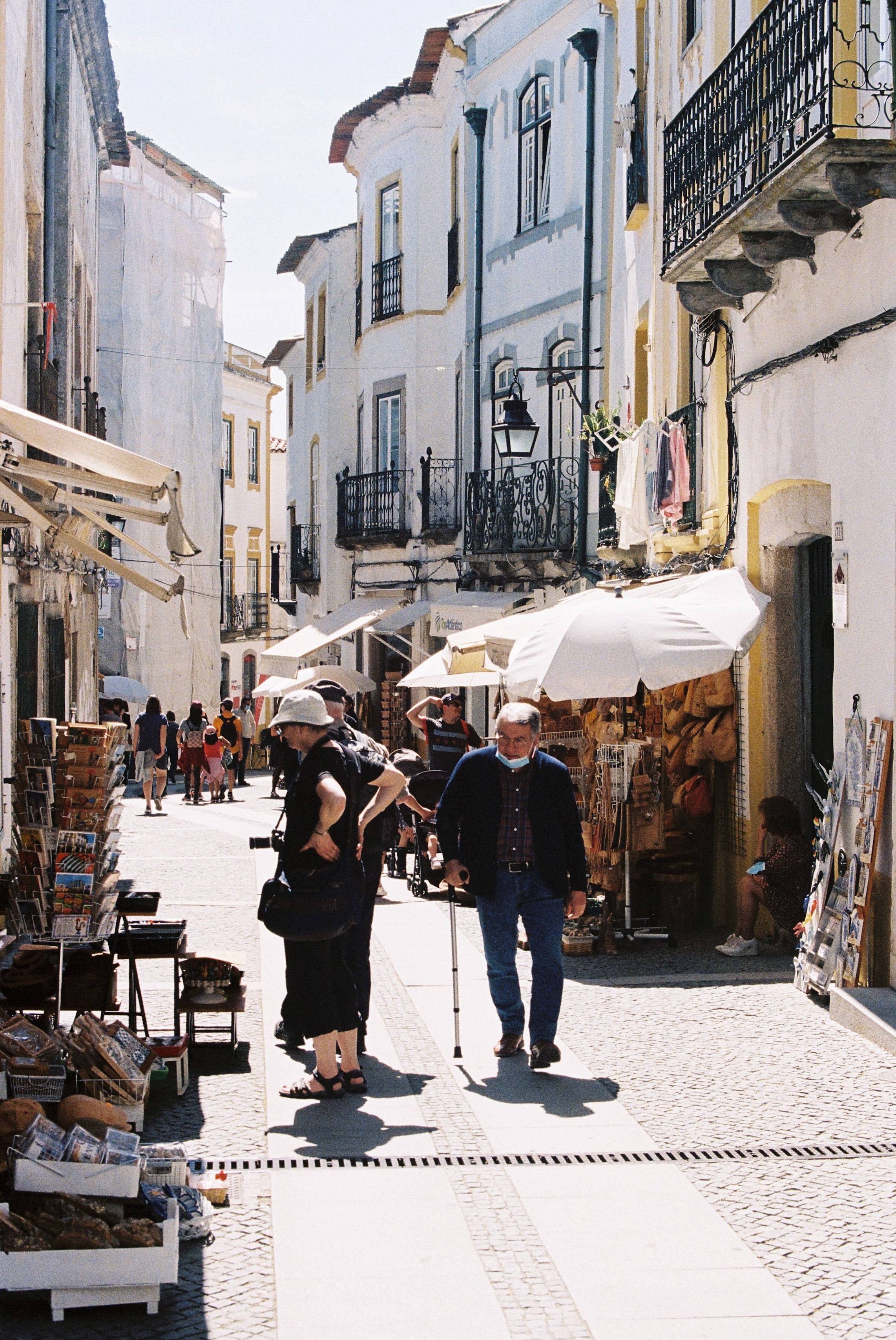 Explore the quaint street market in the historic city of Evora, Portugal, with vibrant stalls and classic architecture.
