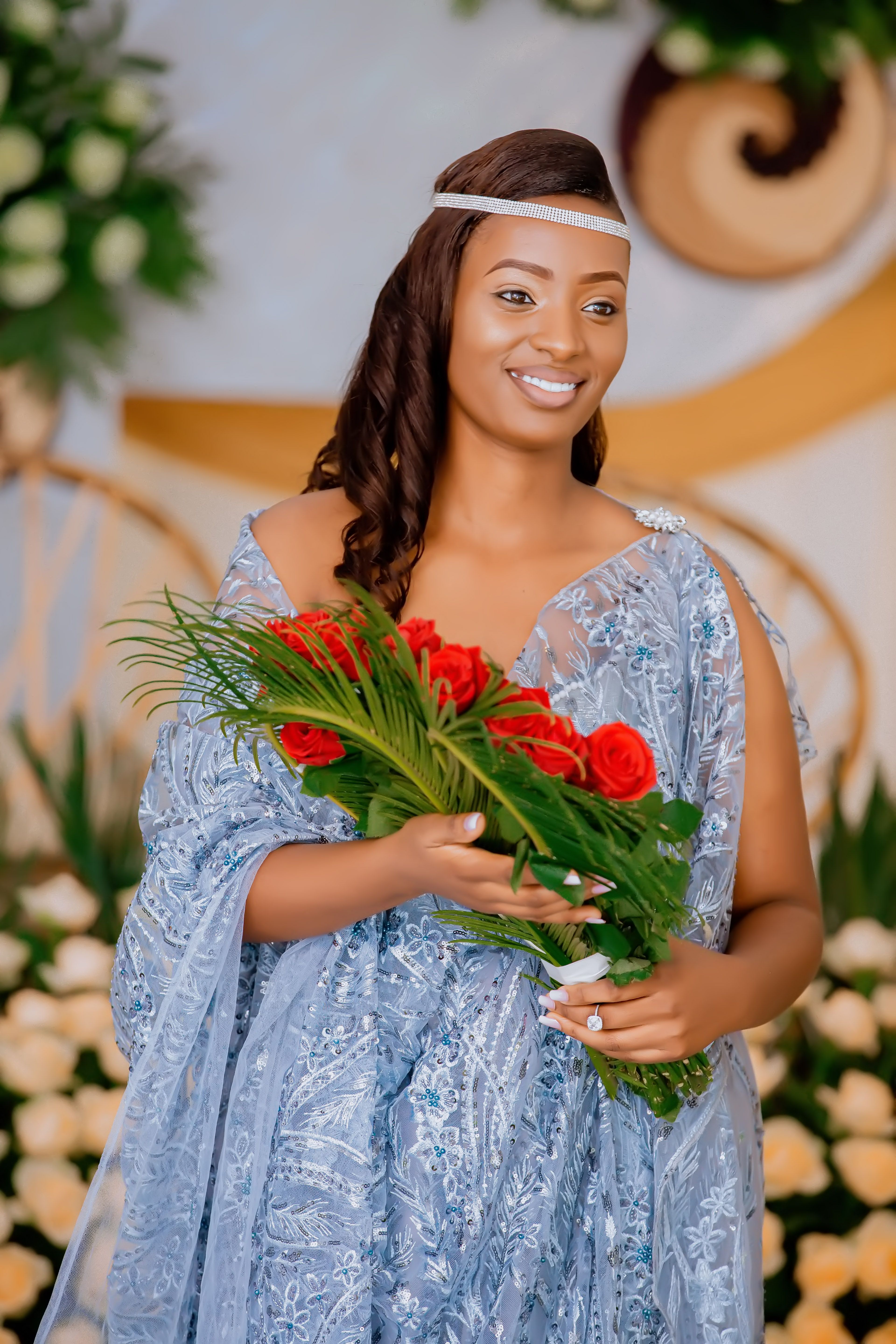 A Bride Smiling while Holding a Bouquet of Flowers · Free Stock Photo