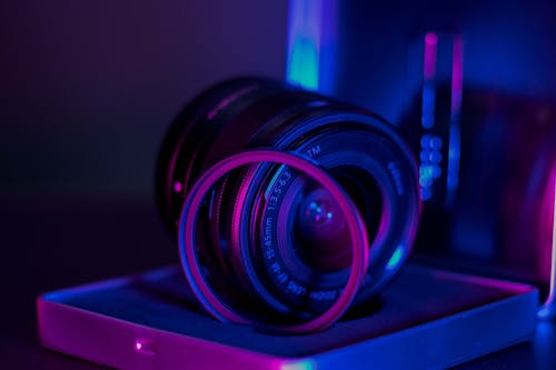 Close-up of Camera Lens Illuminated in Purple 