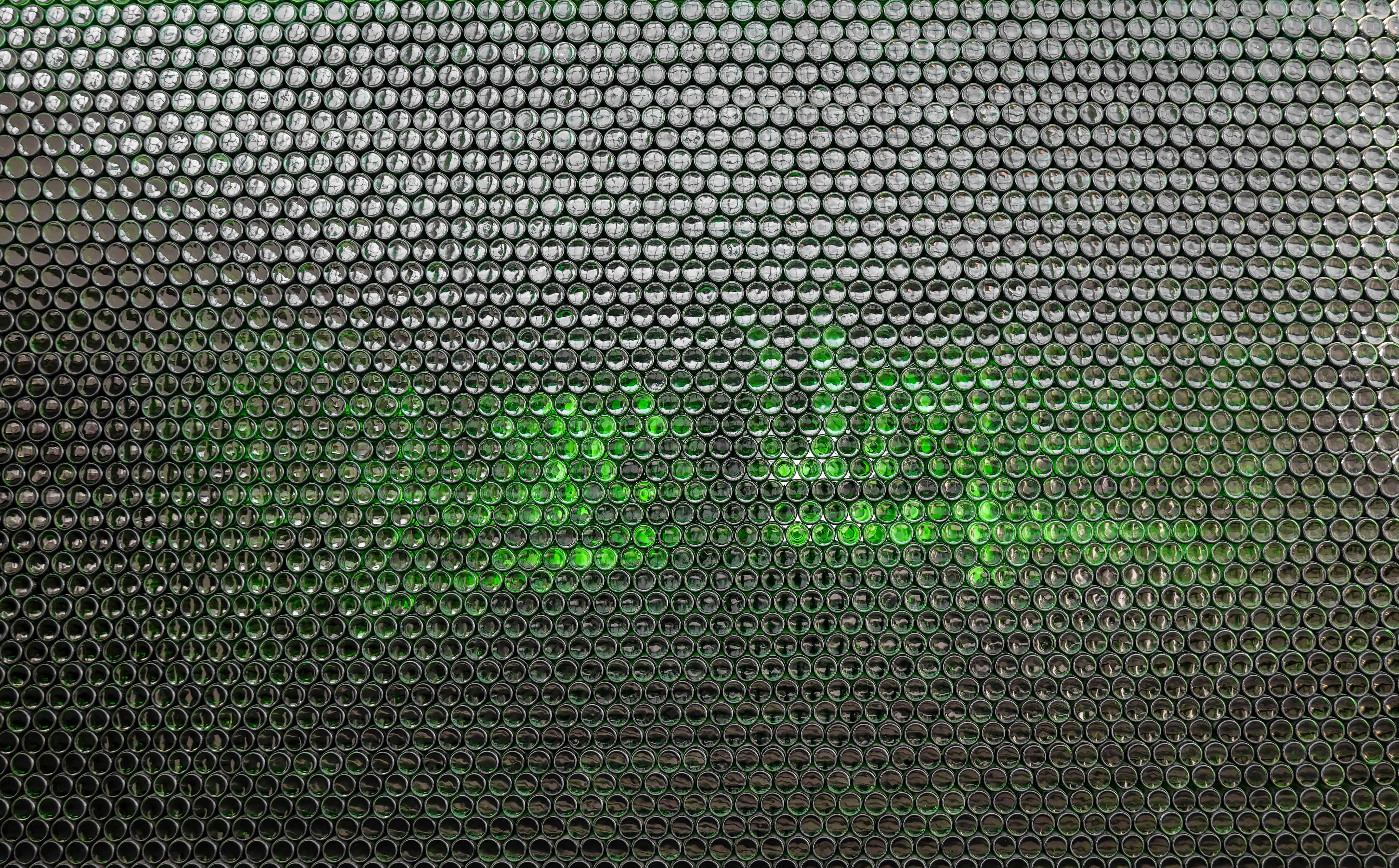 Close-up abstract honeycomb texture background with green illumination.