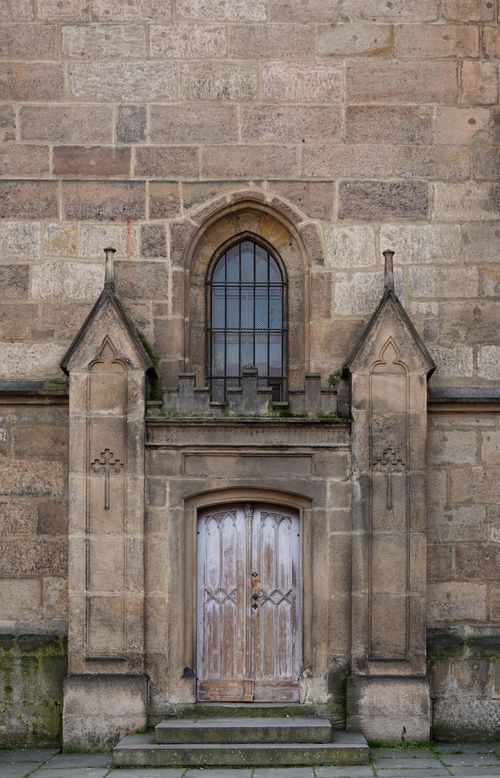 Free A classic stone church entrance showcasing Gothic architecture and symmetry. Stock Photo