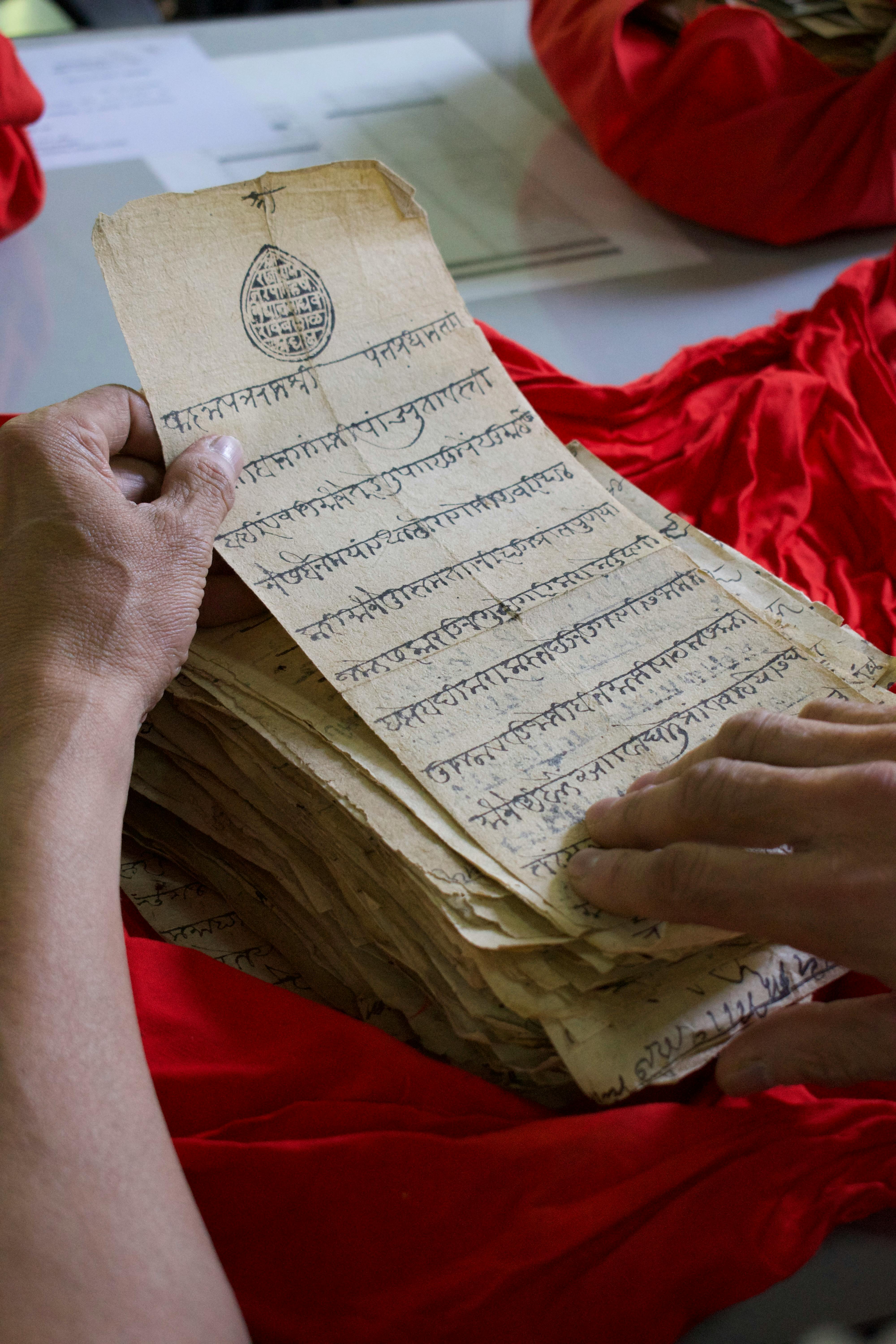 hands of a person examining old pages