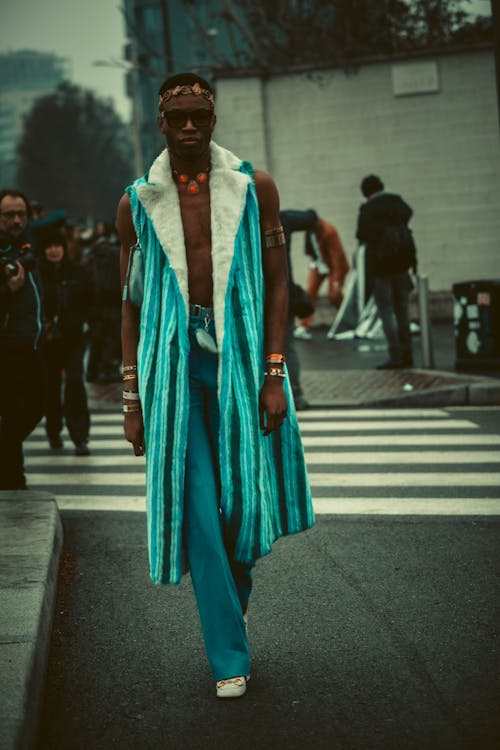 Model in Blue Pants and Sleeveless Coat