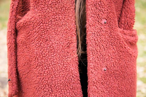 Red wool like winter coat with female hair strand 