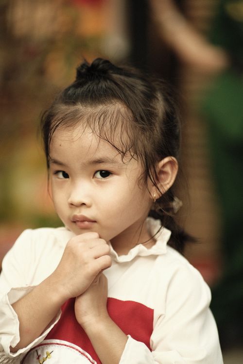 Free Adorable young girl in traditional dress, captured in Hồ Chí Minh City, Vietnam. Stock Photo