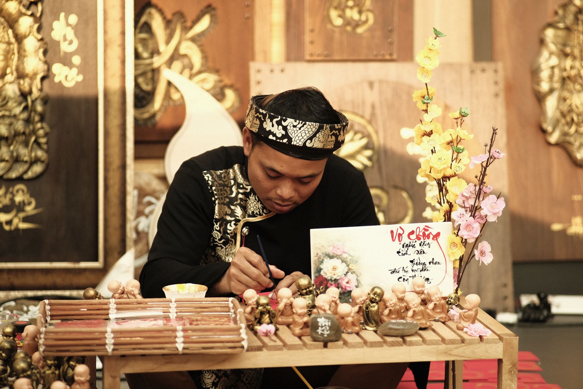 A Vietnamese craftsman creating traditional art in Ho Chi Minh City, surrounded by cultural decorations.