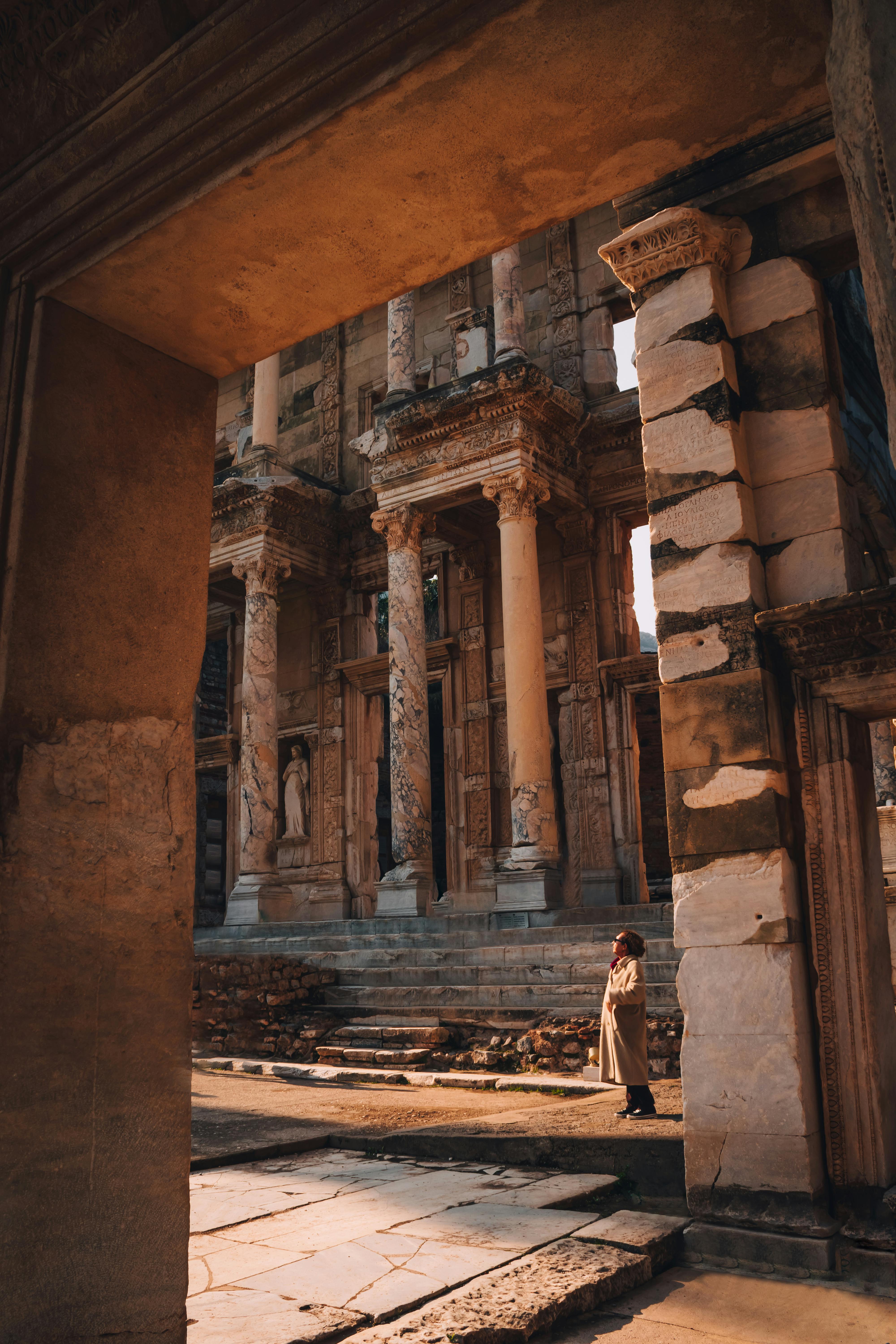 Discover the historic Library of Celsus in Ephesus, Turkey with a solitary traveler exploring its ancient ruins.
