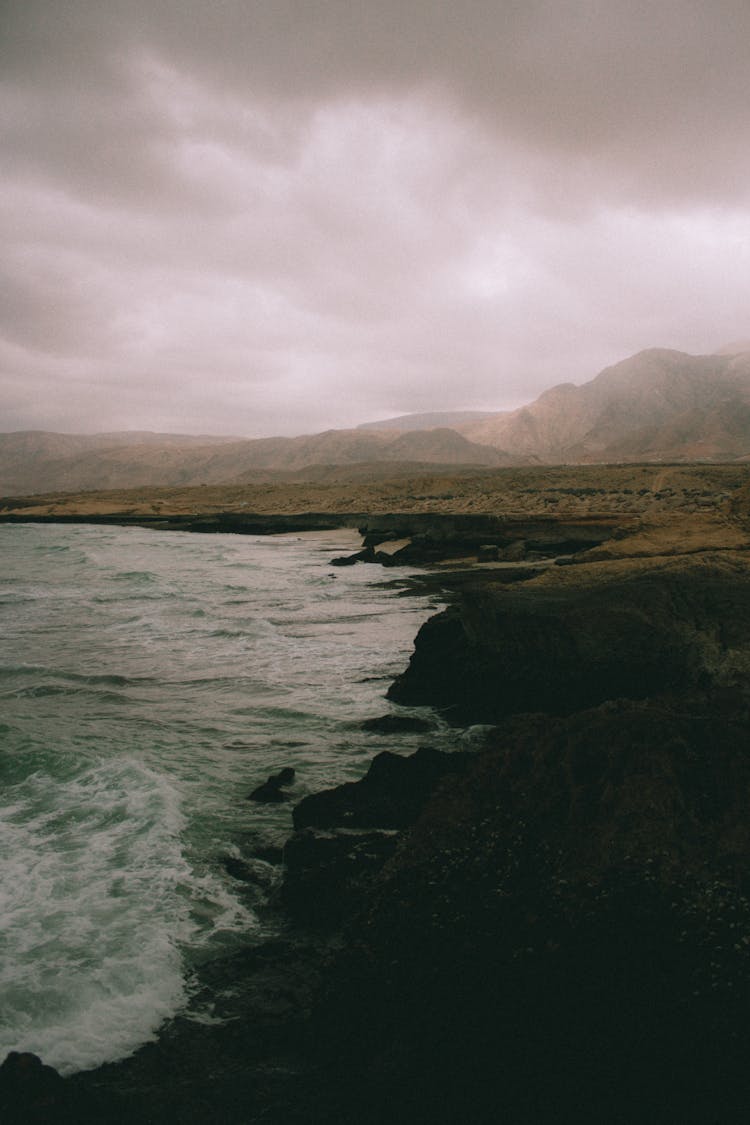 Waves Crashing Onto Misty Shore