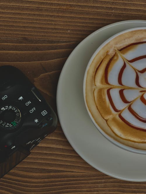 Free A Cup of Coffee and a Camera on a Table  Stock Photo