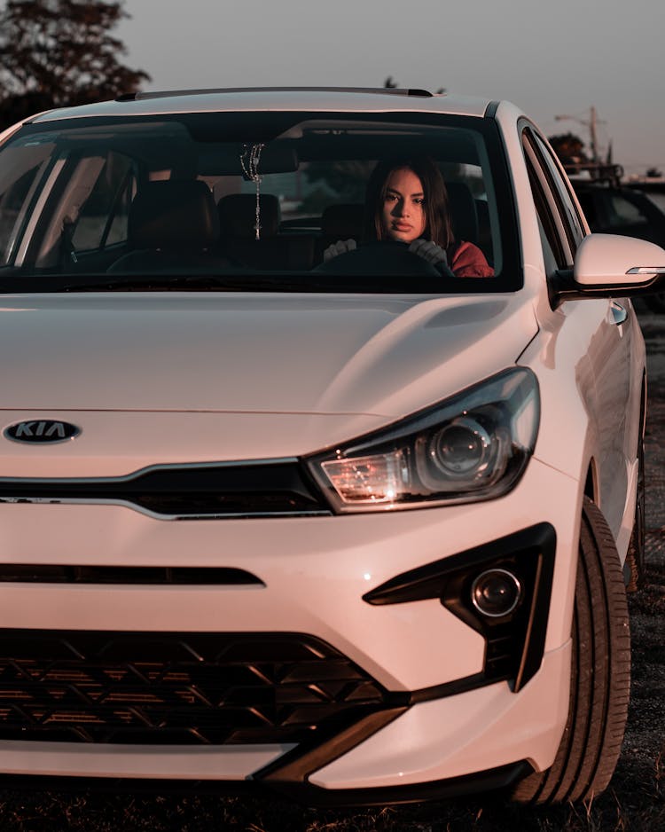 Photo Of A Woman Driving A White Car