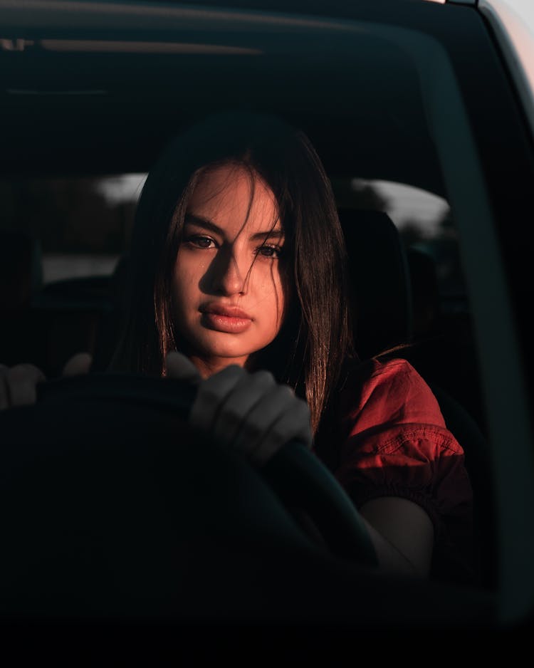 A Woman Driving A Car 