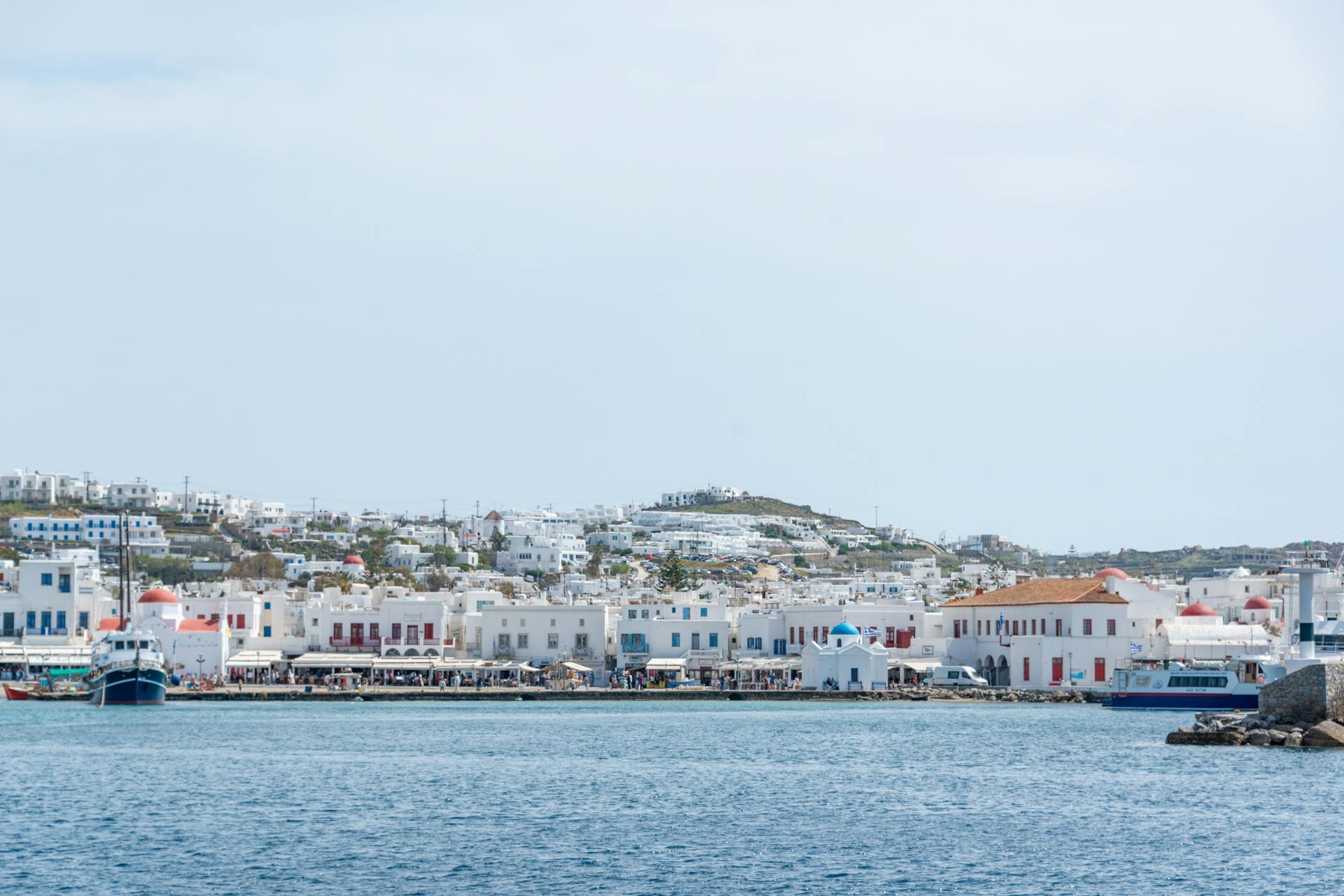 Serene coastal scene of Mykonos with traditional Greek architecture and blue sea.