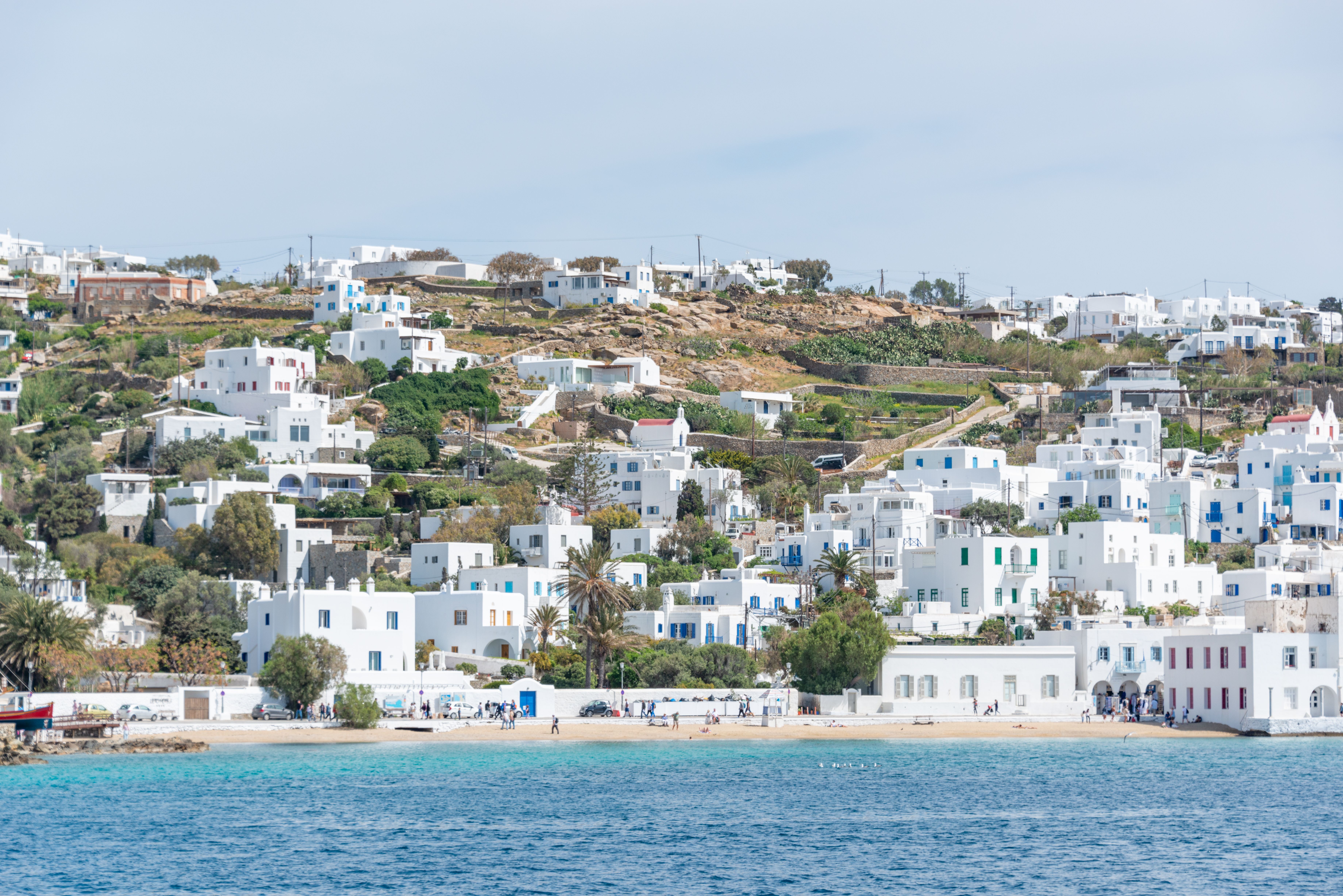 Free A picturesque coastal town with iconic white Cycladic architecture on a sunny day in Greece. Stock Photo
