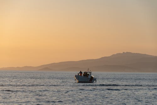 Fishing Boat on the Sea at Sunset 