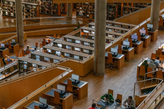 Spacious interior view of Bibliotheca Alexandrina showcasing wooden study areas and computers.