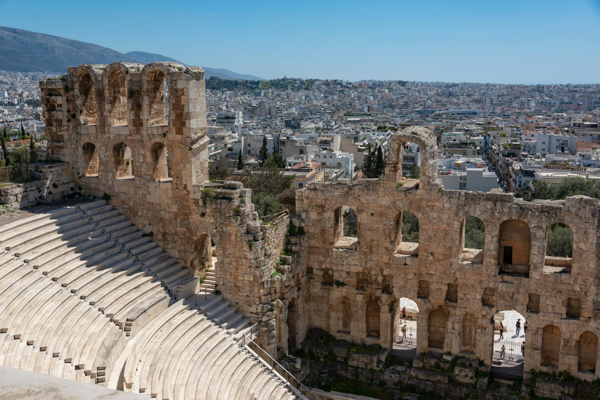 Explore the ancient Odeon of Herodes Atticus amphitheater with city backdrop.