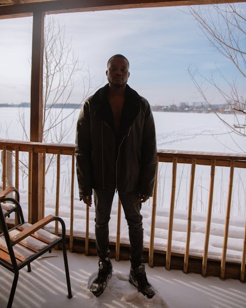 Man Standing on the Porch Covered by Snow 