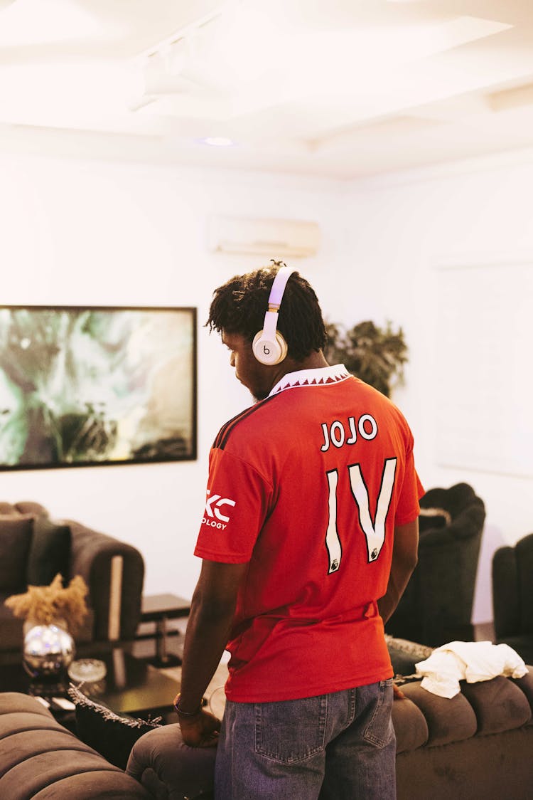 Back View Of Man Wearing White Headset 