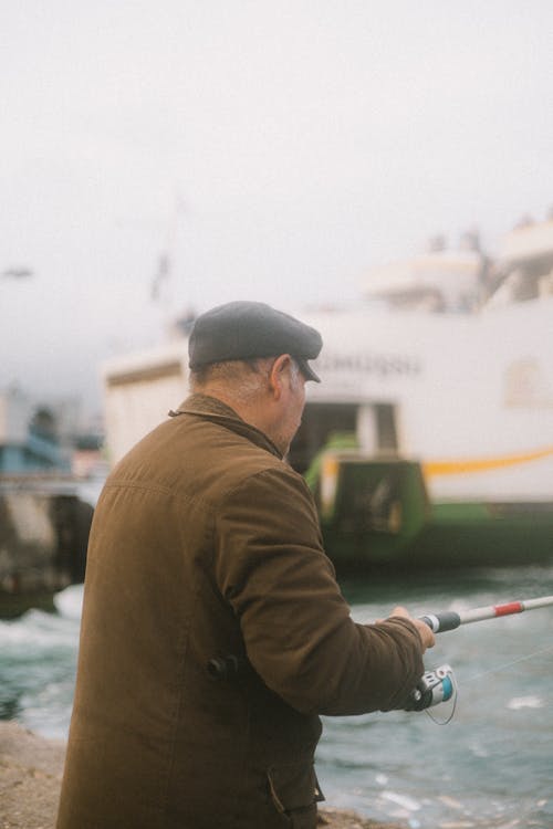 Elderly Man Fishing on a Pier 