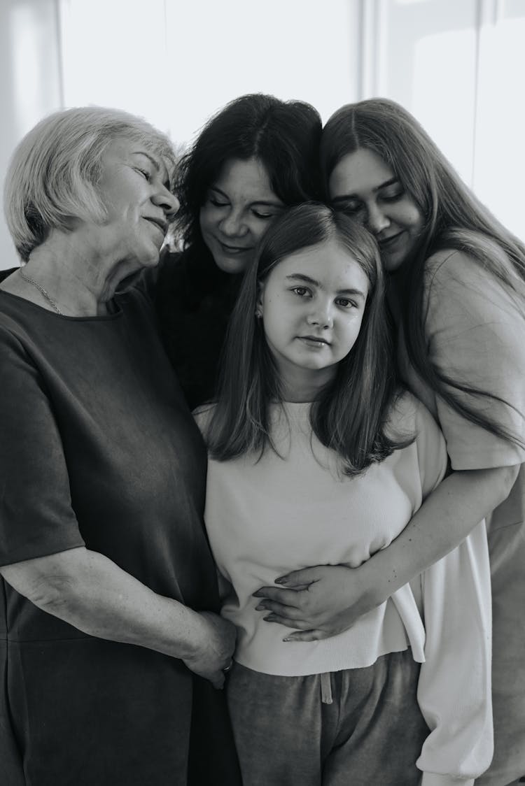 Black And White Photo Of Women Hugging Young Girl