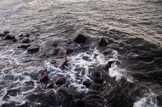 Rugged rocks along the Baltic Sea coast in Bad Doberan, Germany, showcasing nature's raw beauty.