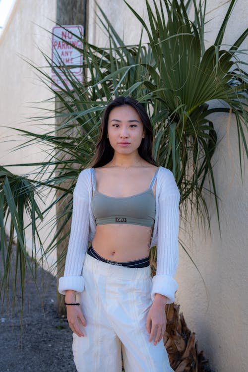 Young Woman in a Sports Bra and White Pants 