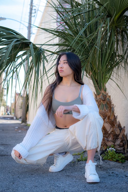 Squatting Woman in Top and White Clothes