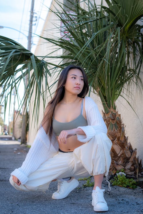 Young Woman in Sports Bra and White Pants 