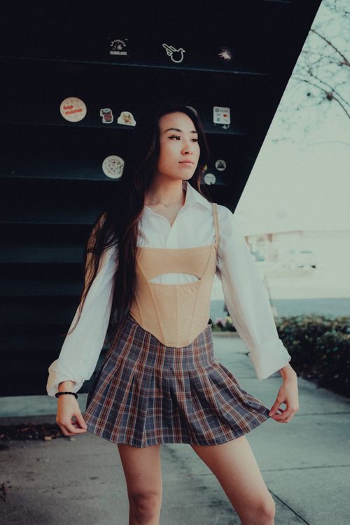 woman in pleated plaid mini skirt y2k outfit